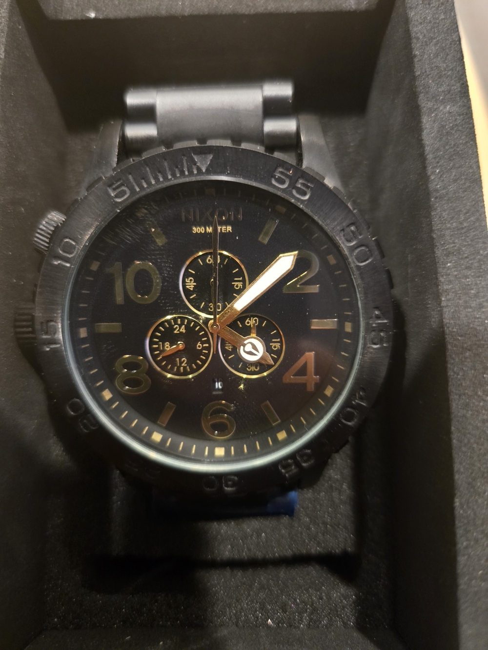 Nixon Men’s Black and Gold Analog Watch